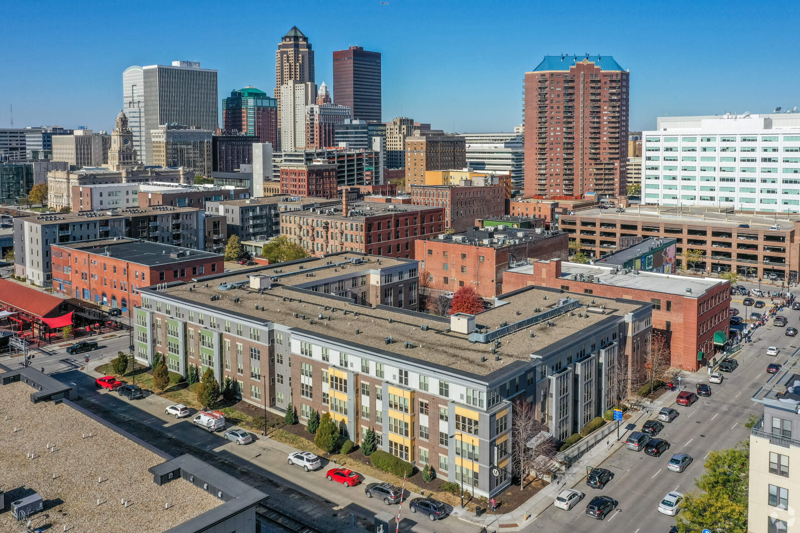 Metro Lofts apartment building exterior with the Des Moines skyline behind it.