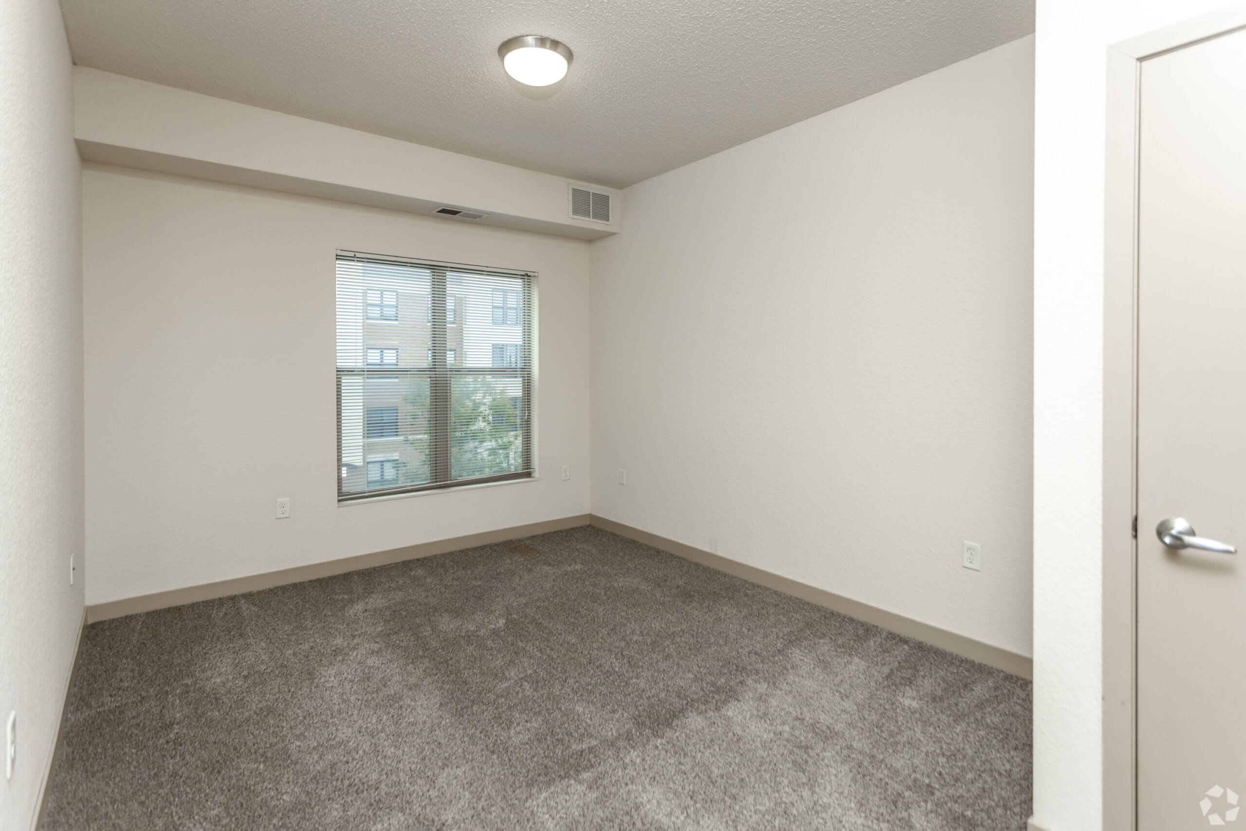 Metro Lofts Apartments interior unit image. Neutral walls and plush carpet.