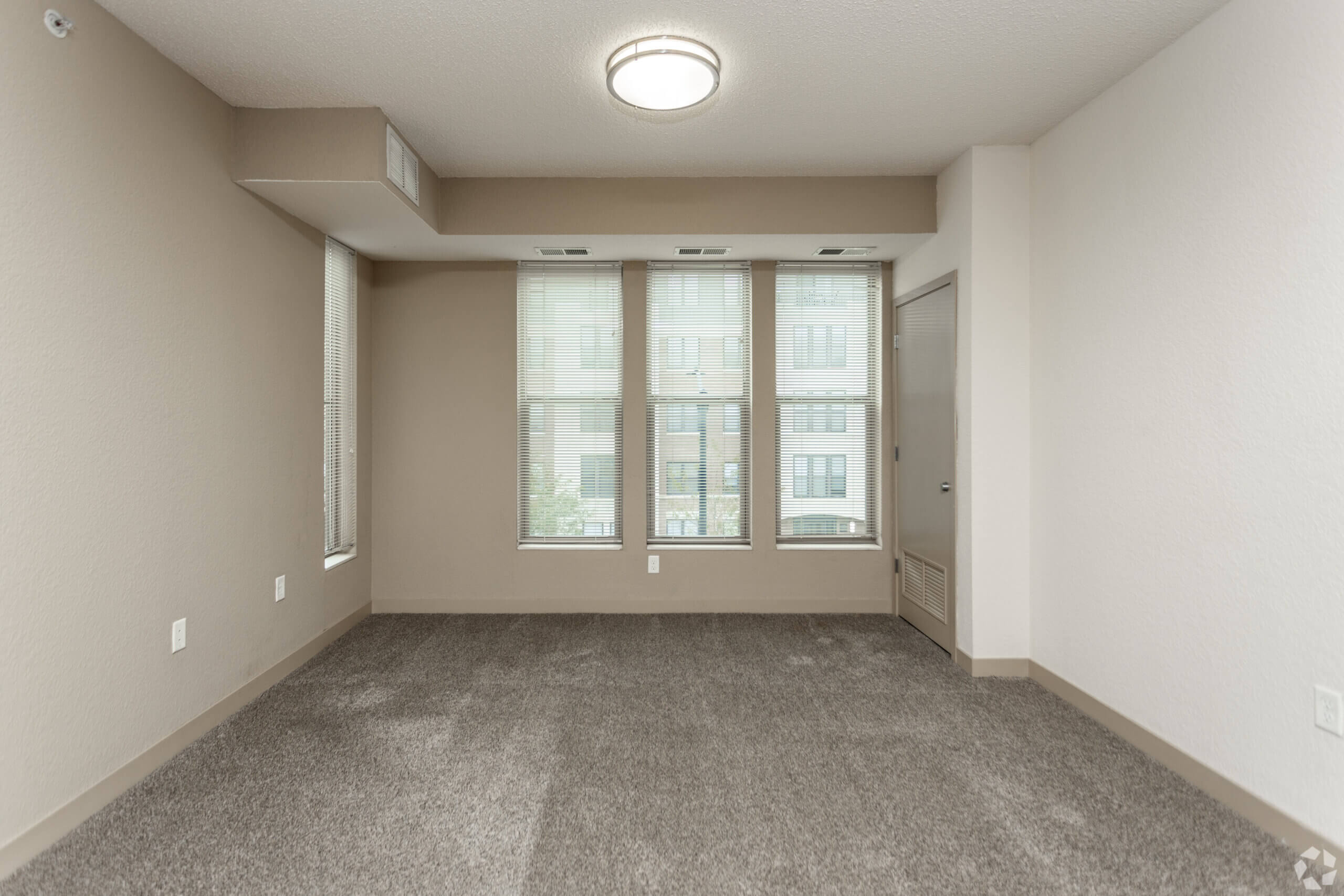 Metro Lofts Apartments interior unit image. Neutral walls and plush carpet.
