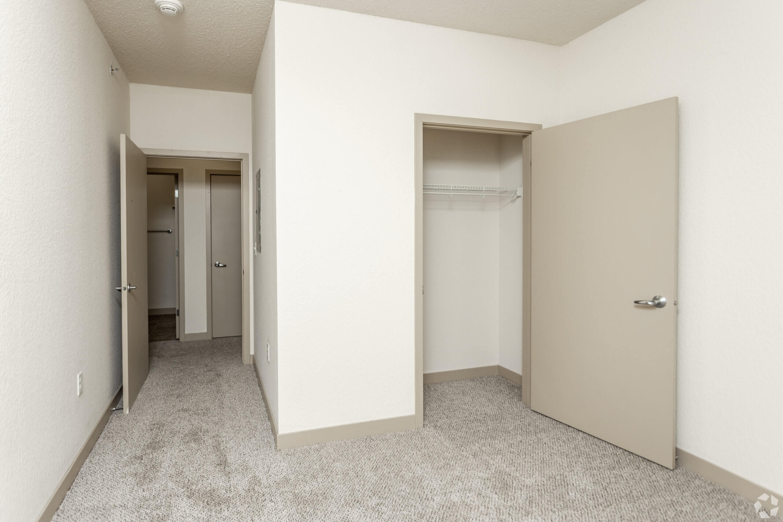 Metro Lofts Apartments interior unit image. Neutral walls and plush carpet.
