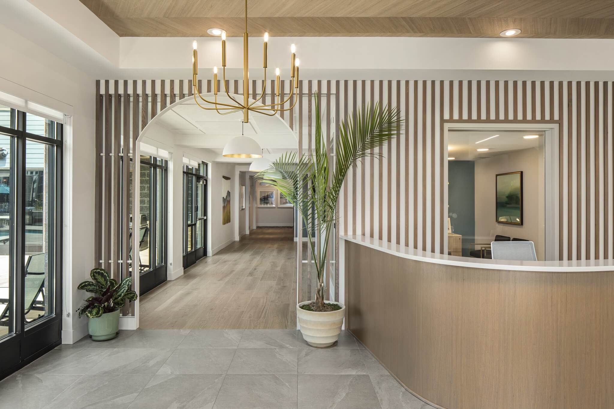 Aster at Riverdale Station beautiful lobby with indoor plant, large desk, and arch entryway