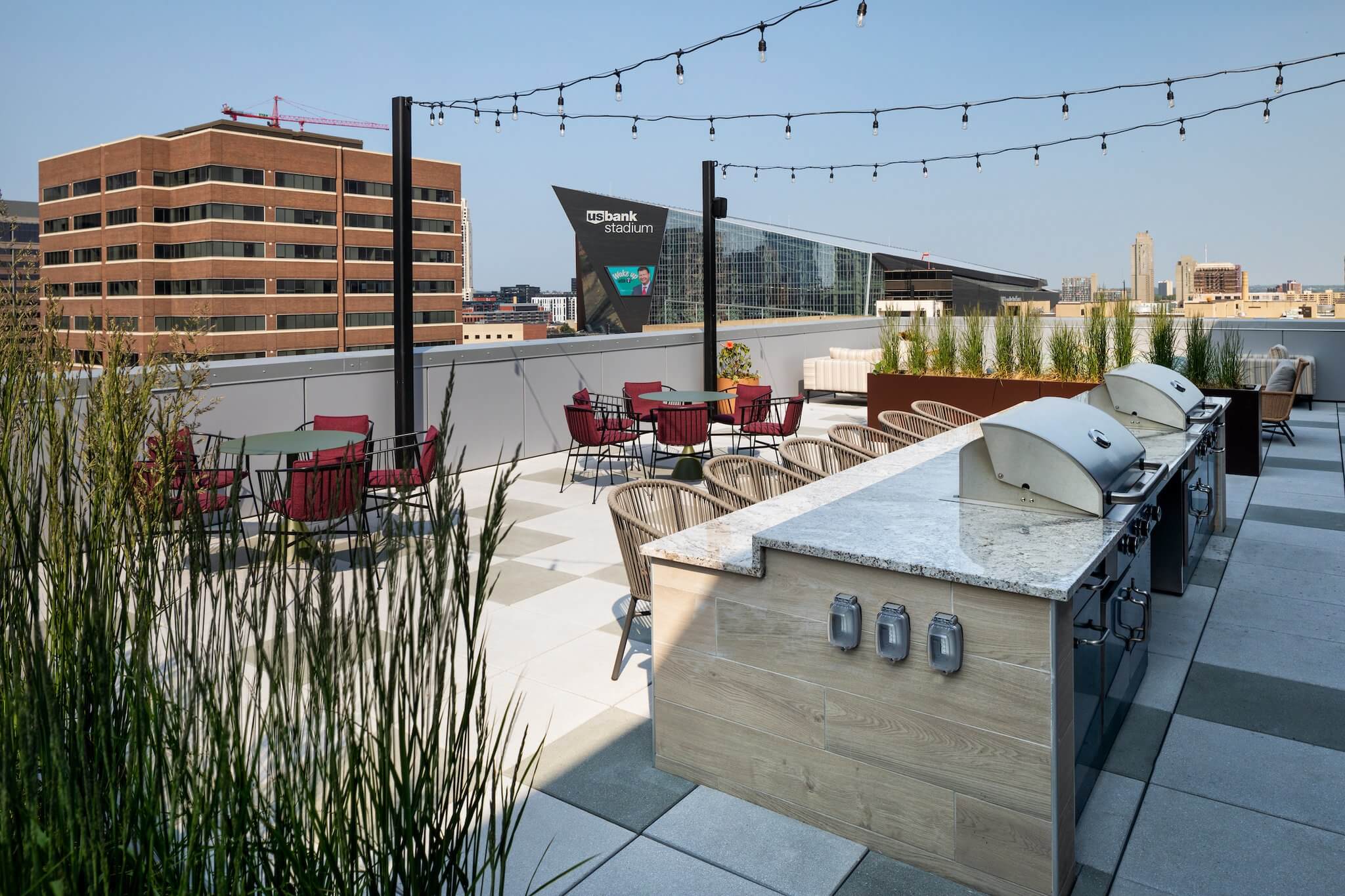 Moment apartments rooftop lounge amenity with views of the U.S. Bank Stadium